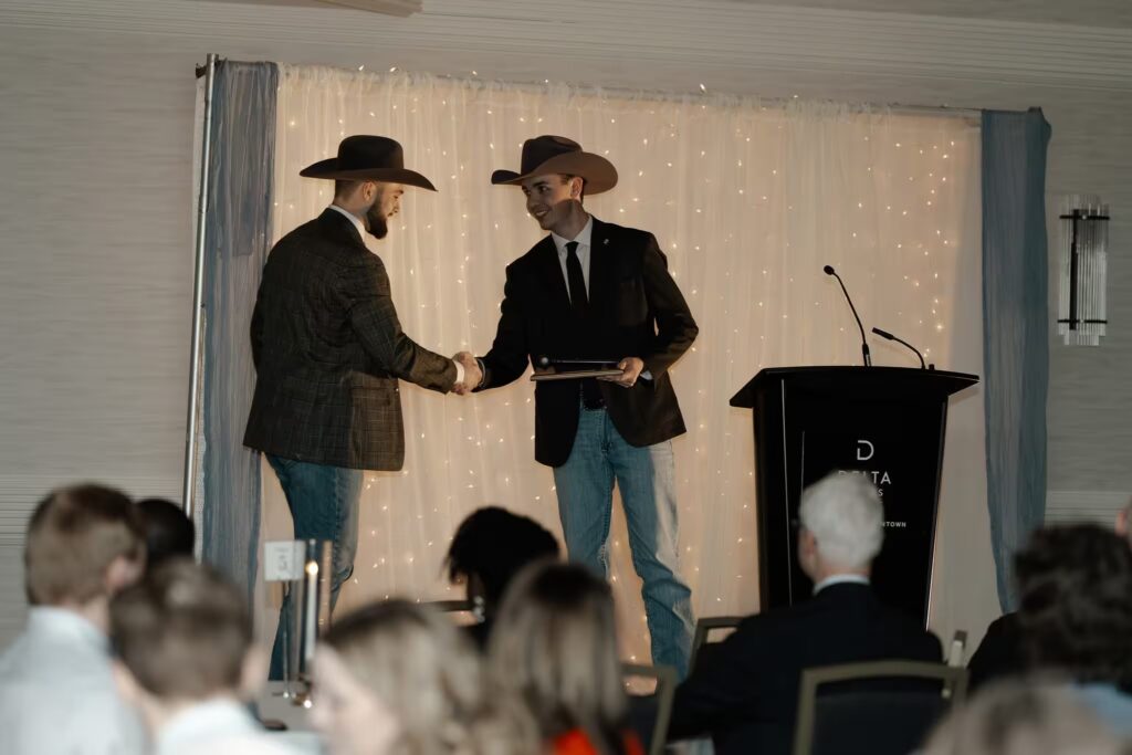 Agro member receiving an award at grad